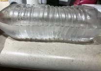 Yooz a half-filled water bottle to make a level